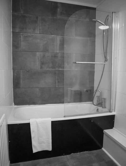 Simple bath with overhead shower— Instyle Shower Screens & Wardrobes in Charmhaven, NSW